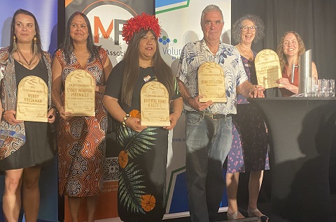 Award winners standing on stage at ceremony